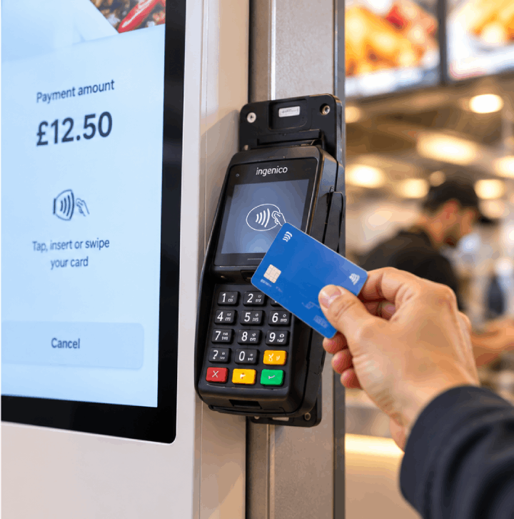 Customer making a card payment using a self-service kiosk
